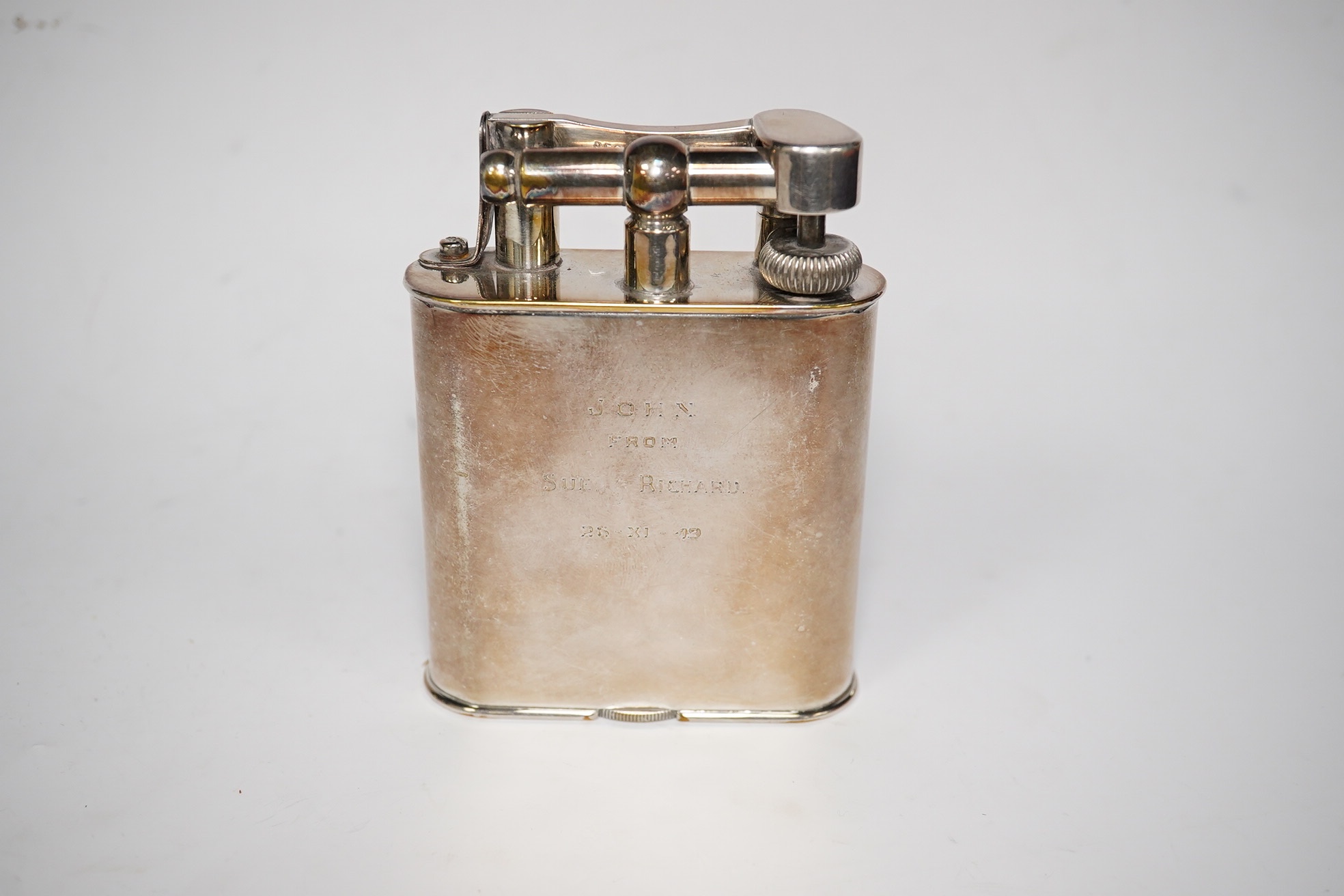 An engraved Alfred Dunhill plated table lighter, 10.7cm. Condition - fair, general wear to the plate